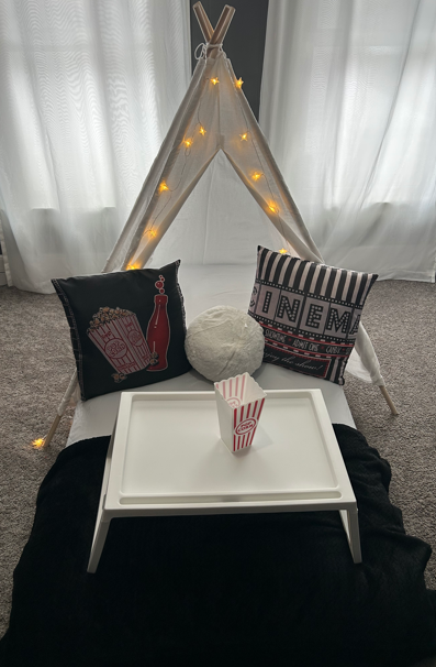 Movie night themed sleepover tent setup